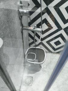 a bathroom with a toilet in the floor of a room at KakoonStudios Balcony Bliss in Ghaziabad