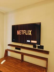 a flat screen tv sitting on a wall at KakoonStudios Balcony Bliss in Ghaziabad