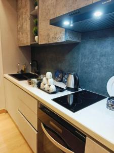 a kitchen with a sink and a stove top oven at KakoonStudios Balcony Bliss in Ghaziabad +1 photo