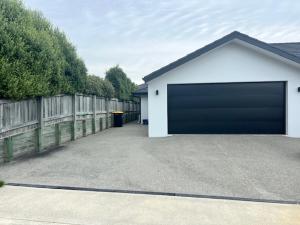 a garage with a large door in a driveway at Hart Road Haven in Richmond