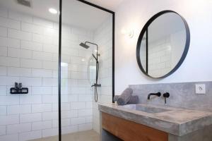 a bathroom with a sink and a mirror at KARMA room in Villa ABSOLUTE Shared Villa in Canggu