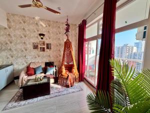 a living room with a couch and a fireplace at Royal Moroccan Escape in Noida in Noida