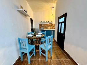 a dining room with a table and blue chairs at Avaroa 350 in Sucre +3 photos