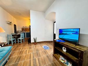 a living room with a large flat screen tv at Avaroa 350 in Sucre