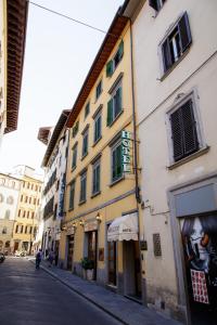 a building on a street next to a street at Hotel Nizza in Florence