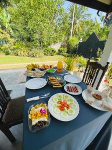 a blue table with plates of food on it at Diddi's in Weligama