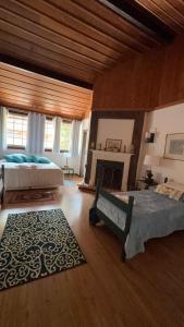 a large bedroom with two beds and a fireplace at Casa do Fachoalto in Petrópolis +224 photos