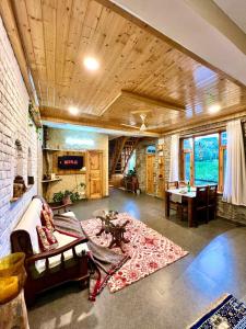 a living room with a couch and a table at Rustic Roots Home Stay in Nagar