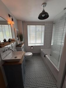 a bathroom with a sink and a toilet and a shower at Highfield Terrace – Cosy Devon Retreat, Close to Beer Beach in Beer