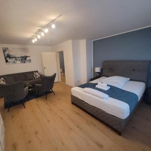a bedroom with a bed and a desk and chairs at Große,Schöne FeWo nähe Schwetzingen-Hockenheim 3 Zimmer mit Balkon in Oftersheim