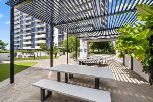 a picnic table in a courtyard with a building at Alcyone at The Corso in Maroochydore