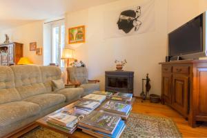 a living room with a couch and a coffee table at Casa Alta in Vizzavona