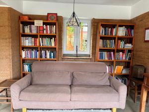 a living room with a couch in front of book shelves at Resort Vishuddhialaya Pvt Ltd in Dhulikhel +11 photos