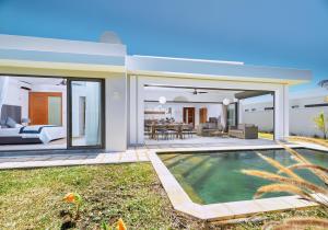 a villa with a swimming pool and a bedroom at Corail Bleu 3-Bedroom Private Pool Villa by LOV Mauritius in Bain Boeuf