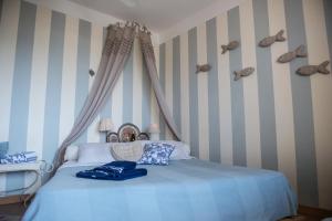 a bedroom with a blue bed with shoes on the wall at Jesolo sea front garden apartment in Lido di Jesolo