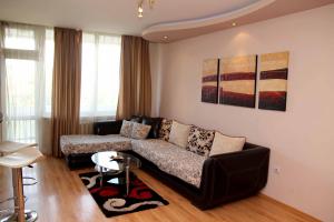 a living room with a couch and a table at Apartments Rosina in Plovdiv