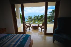 a bedroom with a bed and a view of the ocean at Kingfisher Beach in Unawatuna +57 photos