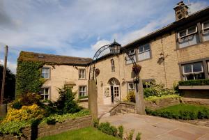 an old stone house with a street light on it at The Fleece Inn at Barkisland in Ripponden