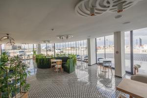 a large room with tables and chairs and windows at Dedem Hotel Dinlenme Tesisleri-Sultanhanı in Sultanhanı