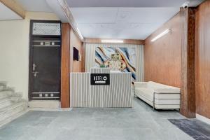 a lobby with a door and a couch and a table at Super Hotel O Dwarka Mor Metro Station in New Delhi
