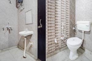 two pictures of a bathroom with a toilet and a sink at Super Hotel O Dwarka Mor Metro Station in New Delhi +37 photos