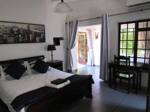 a bedroom with a bed and a table and a desk at House on York in Johannesburg +50 photos