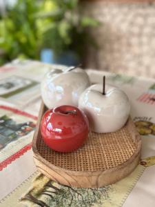 three candles on a wooden plate with a red apple at Oasis Paje in Paje