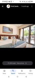 a bedroom with a bed and a view of a window at Vivid sand beach resort in Revadanda