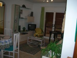 a living room with a couch and a tv at Rosie Apartment in Campoamor
