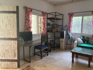 a living room with a desk and a computer in it at Downtown Malindi Apartment in Malindi