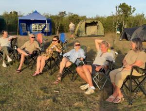 a group of people sitting in chairs in front of a tent at Bwana Renman Campsite in Narok
