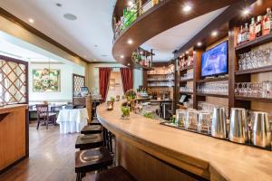 a bar in a restaurant with a counter and chairs at Business & More Boutique Hotel Hamburg in Hamburg