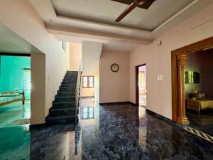 a room with a staircase and a stair case at Laksh Nivas Fields Stay in Udupi