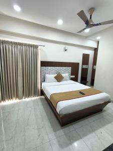 a bedroom with a large bed and a window at Sathya Comforts in Bangalore