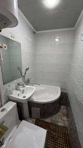 a white bathroom with a sink and a toilet at Home Villa YaaxYa in Bukhara +34 photos