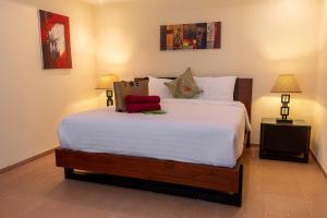 a bedroom with a large white bed with two lamps at Windy Villa by Utalay Koh Chang in Ban Khlong Son