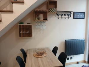 a dining room with a wooden table and chairs at Duplex 4 Personnes 5 Minutes a pied du petit port et 10 Minutes de la plage in Le Havre
