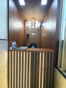 a reception desk in a room with a ceiling at Sathya Comforts in Bangalore