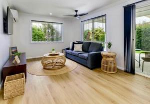 a living room with a couch and a table at House 4-bed 2-bath Caboolture South in Caboolture
