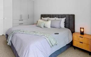 a bedroom with a large bed and a night stand at House 4-bed 2-bath Caboolture South in Caboolture