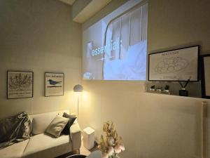 a living room with a couch and a projection screen at 샤인 스테이 in Kung-mal