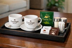 a tray with two coffee cups on a table at Lavanya Holiday Resort Kataragama in Kataragama