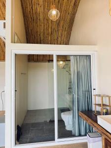 a bathroom with a glass door leading to a shower at Doi Chang Triple A Coffee in Ban Huai Khai +91 photos