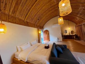 a bedroom with a large bed and a couch at Doi Chang Triple A Coffee in Ban Huai Khai