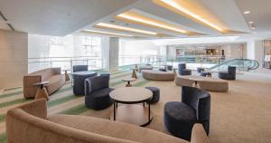 a lobby with couches and tables and chairs at Seagaia Forest Condominiums in Miyazaki +26 photos