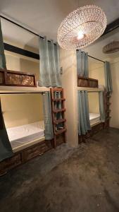 two bunk beds in a room with a chandelier at Ginhawa Stay Mixed dorm 6 Bed in Burgos