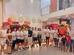 a group of people posing for a picture in a building at Nét Việt House Hotel Market & Bridge Centre Soc Trang in Soc Trang