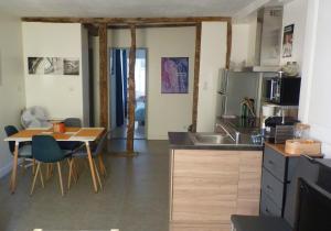 a kitchen with a sink and a table with chairs at Le Libération in Limoges
