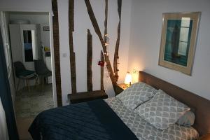 a bedroom with a bed with a blue comforter at Le Libération in Limoges