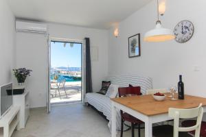 a living room with a table and a couch at Apartments Nikolina in Podgora